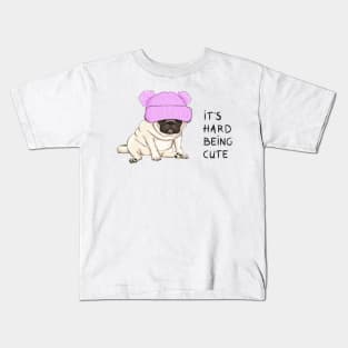 funny pug puppy dog sitting down with pink knitted hat and text its hard being cute Kids T-Shirt